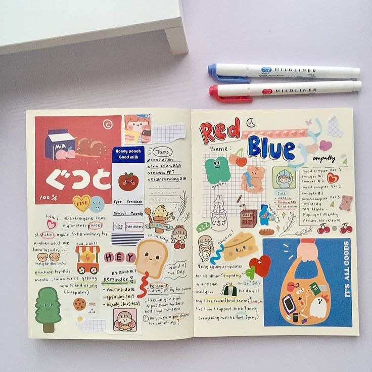 an open book with stickers on it next to two markers and a pencil,