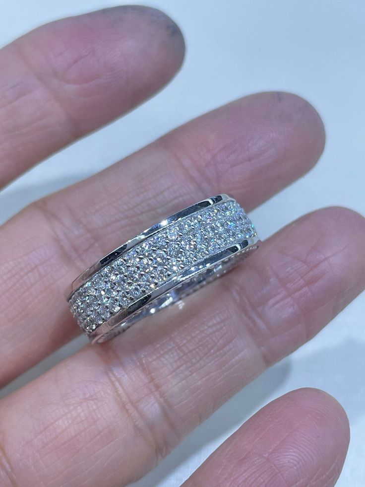 a person's hand with a wedding ring on it