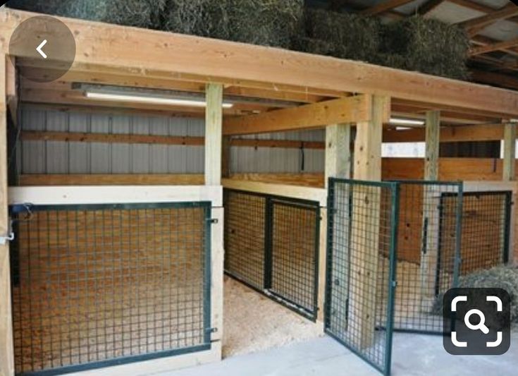 the inside of a barn with hay in it