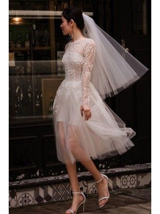 a woman is walking down the street wearing a wedding dress