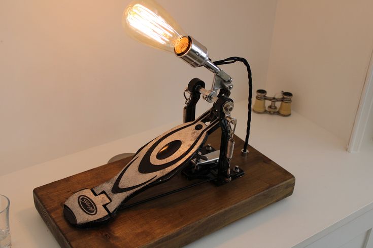 a table lamp sitting on top of a wooden board