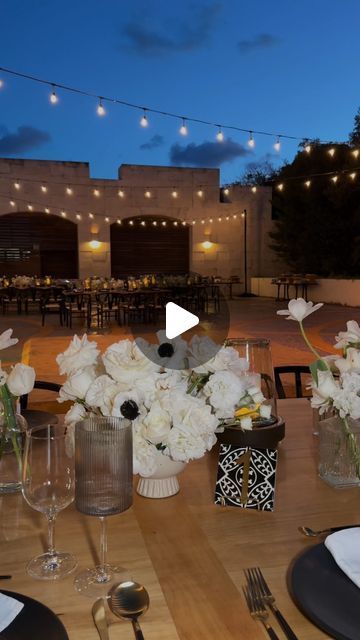 the table is set with white flowers and candles