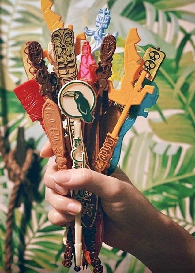 a person holding an assortment of fake toothbrushes