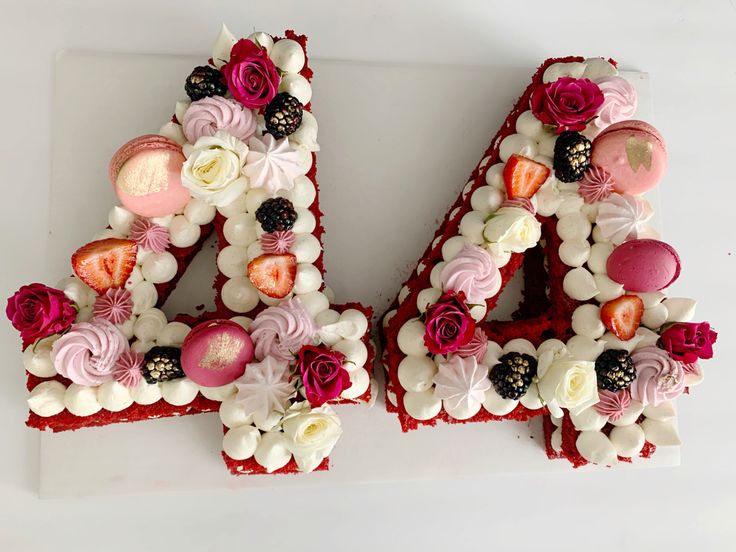 the letters are made out of cake and decorated with flowers on top of each letter