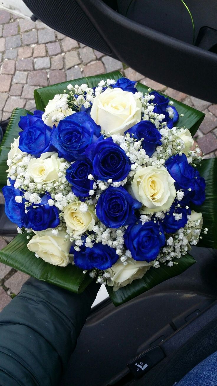 a bouquet of blue and white roses on a motorcycle