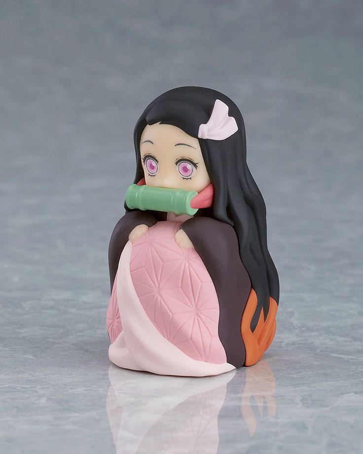 a figurine is sitting on the floor with a toothbrush in its mouth