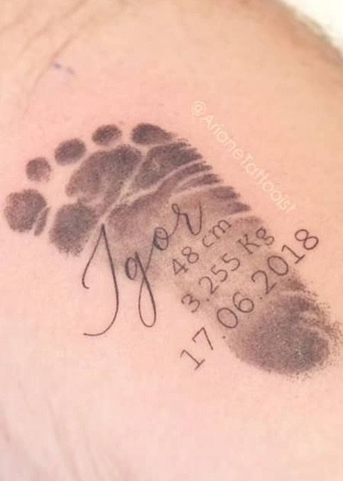 a close up of a person's arm with a hand and foot print on it