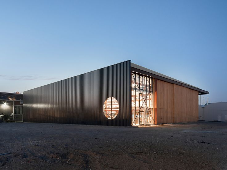 the building is made out of black corrugated