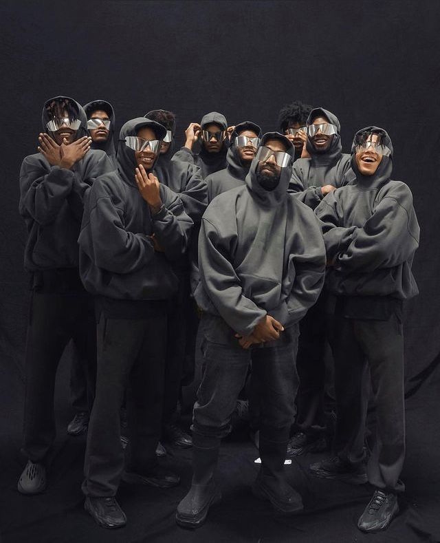 a group of people with their faces covered in masks and covering their eyes are posing for the camera