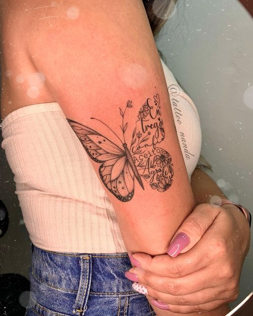 a woman's arm with a butterfly tattoo on the left side of her body