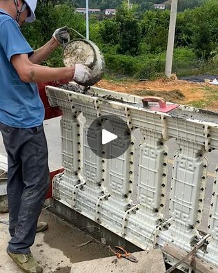 a man in blue shirt and white helmet working on an object