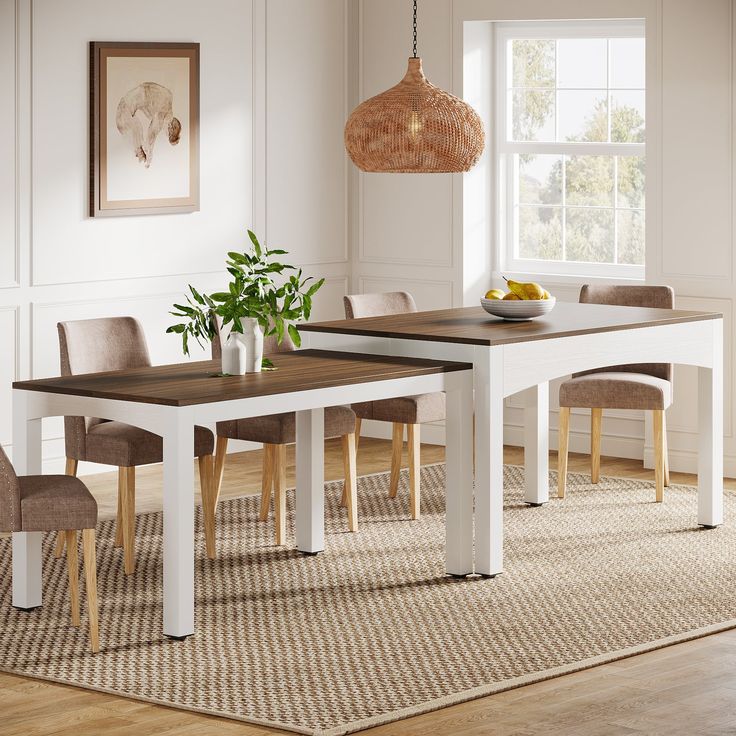 a dining room table with chairs and a bowl of fruit on the table next to it