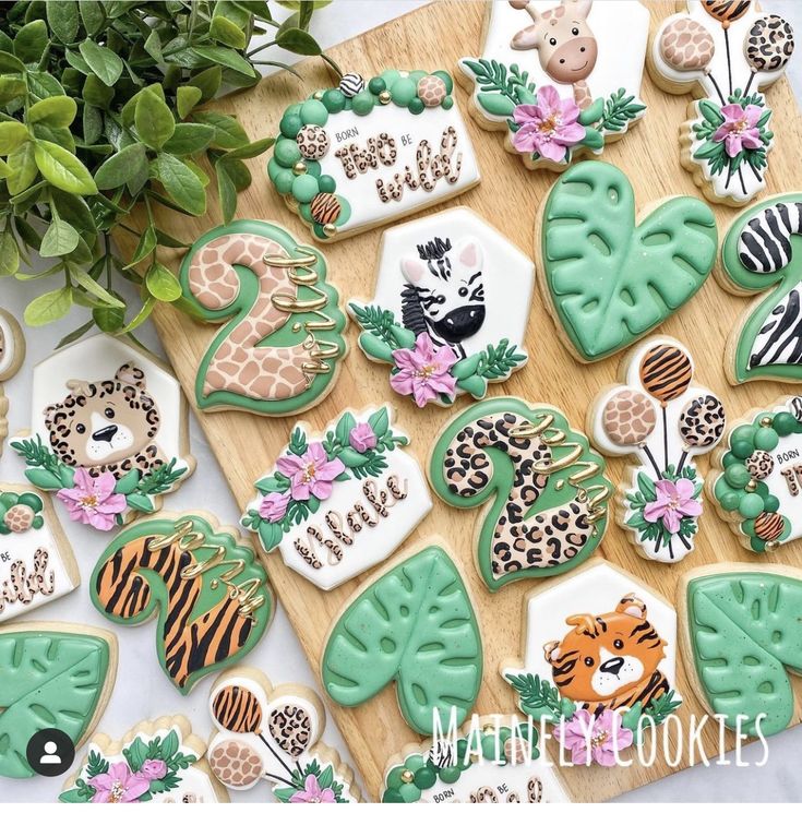 cookies decorated with animal and plants on a table