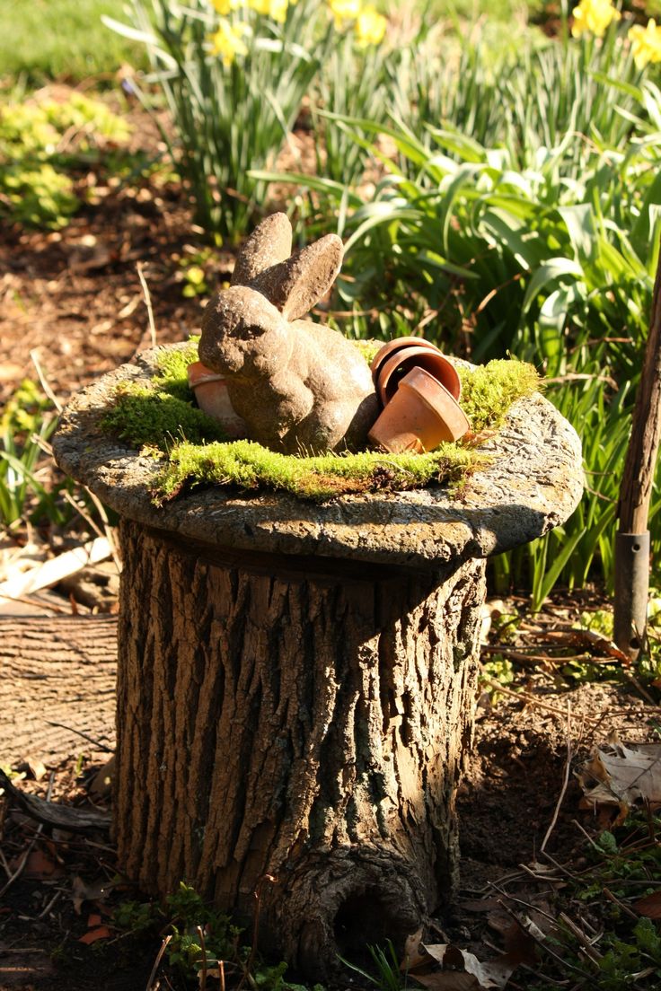 a stuffed animal sitting on top of a tree stump