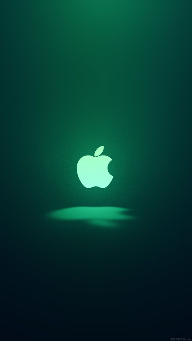 an apple logo is glowing in the dark green light, with only one shadow on the floor