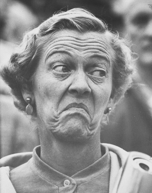 black and white photograph of an old woman making a face