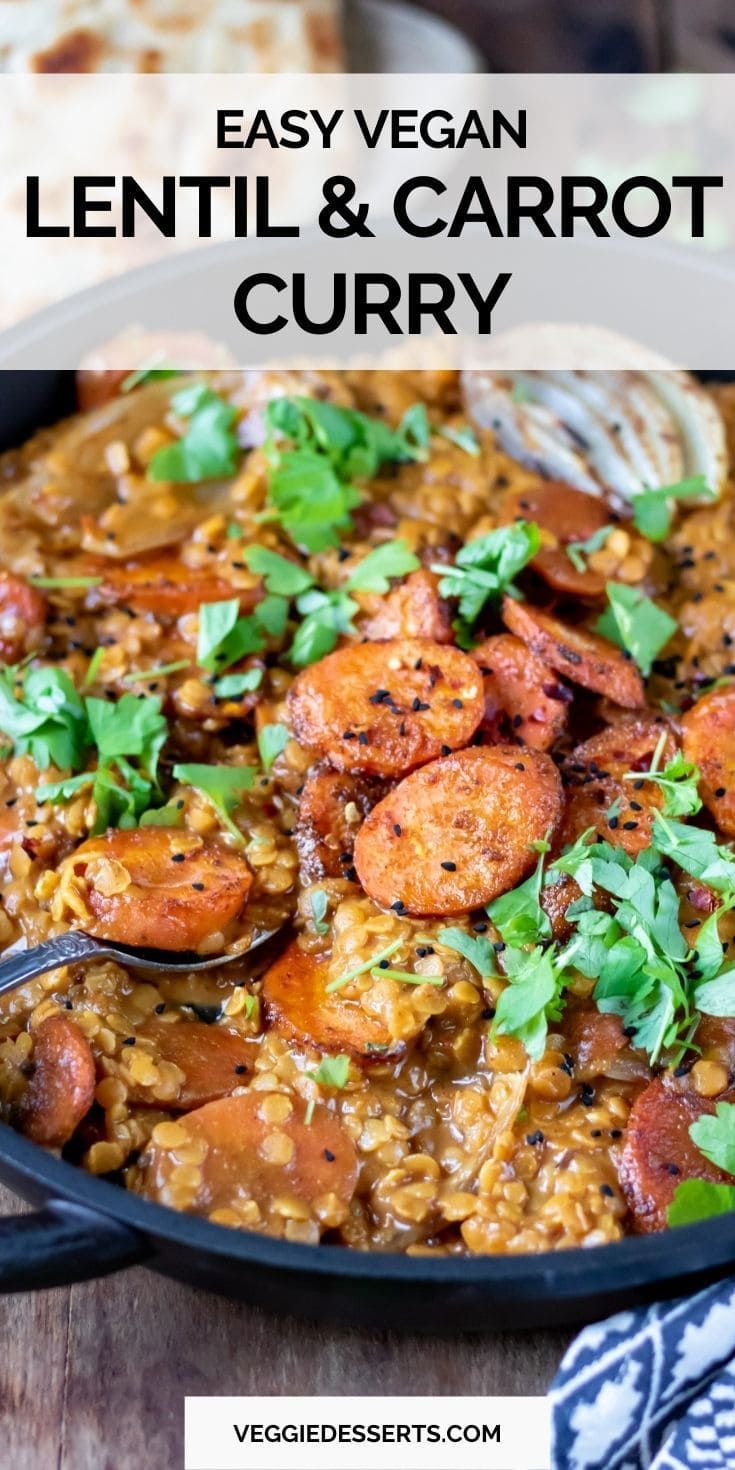 lentil and carrot curry in a skillet with spoons, garnished with parsley