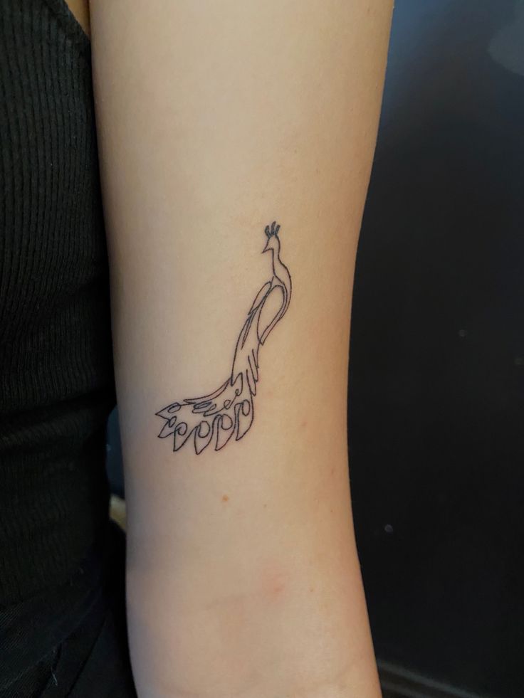 a woman with a tattoo on her arm