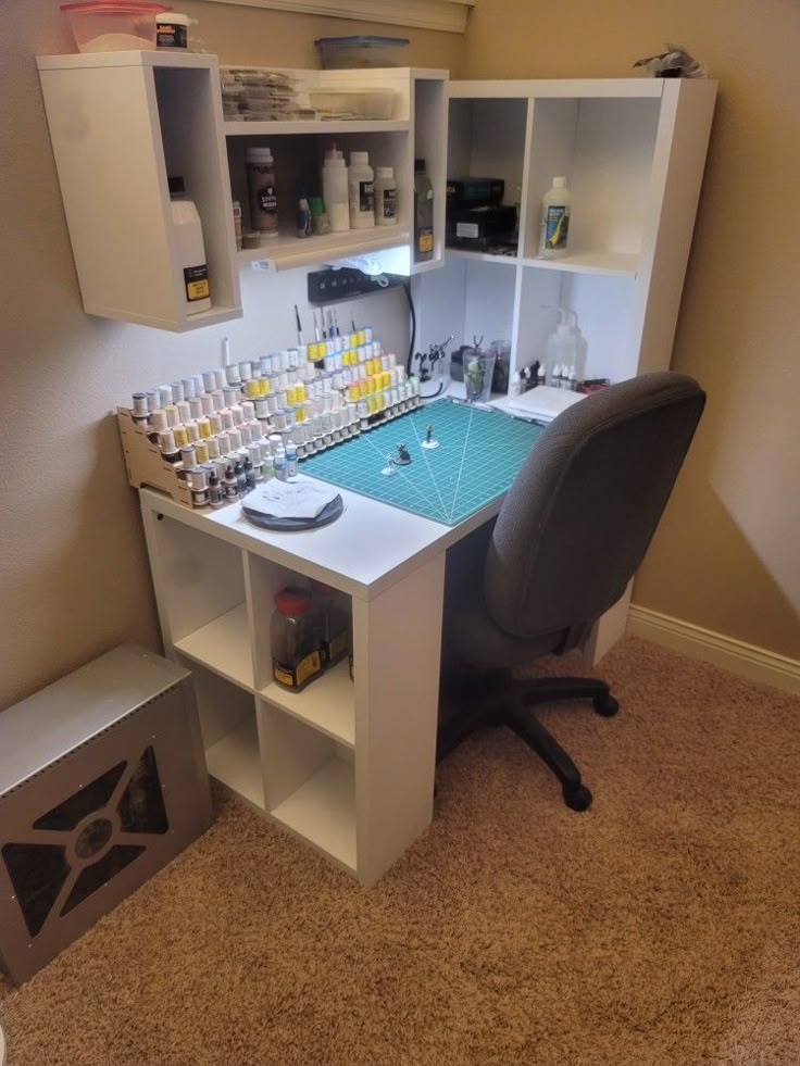 an office desk with many bottles on it and a chair in front of the desk