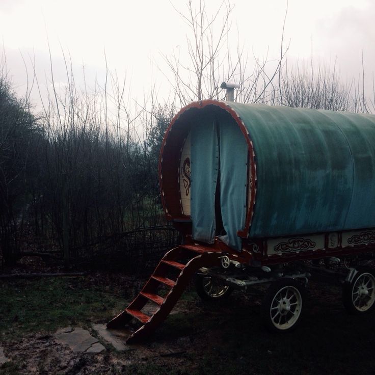 an old covered wagon with a ladder attached to it