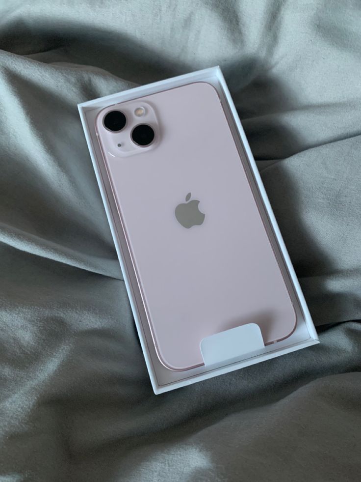 an iphone case sitting on top of a bed