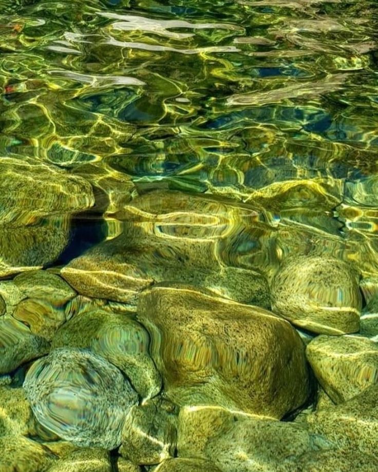 the water is crystal green and has rocks under it, as if they were floating on top of each other