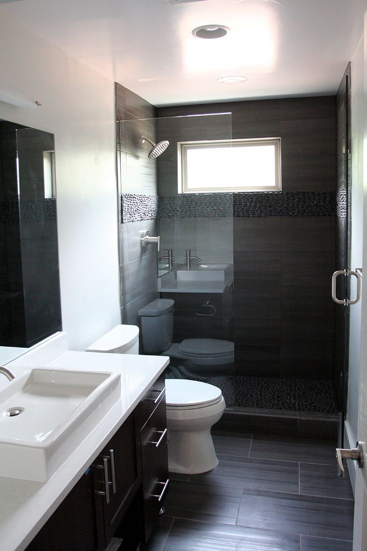 a bathroom with two sinks, a toilet and a stand up shower stall in it