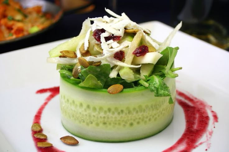 a salad in a cucumber with almonds on the side