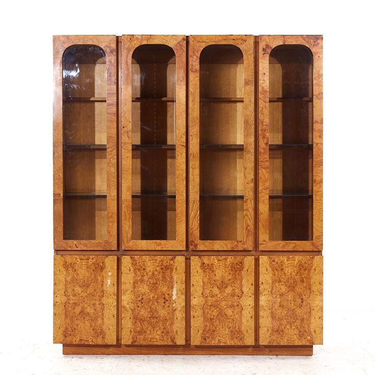 an art deco bookcase with glass doors and wood panels on the front, in good condition