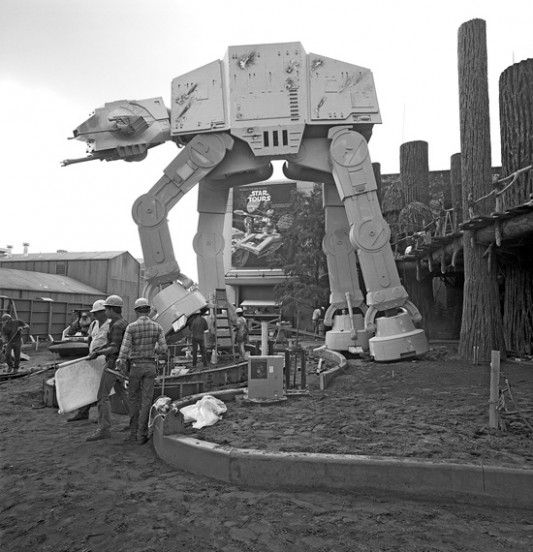 people are standing in front of a giant robot