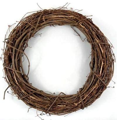 a close up of a wreath made out of twigs on a white background with clippings