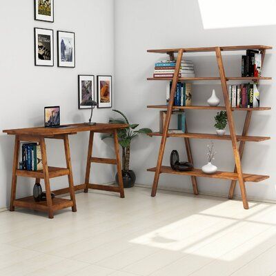 a white room with two wooden shelves and pictures on the wall, one shelf is holding books