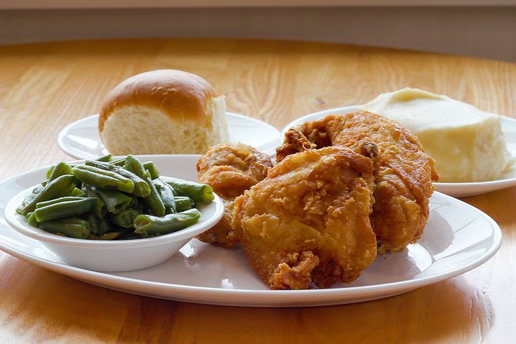 fried chicken, green beans and bread on a white plate