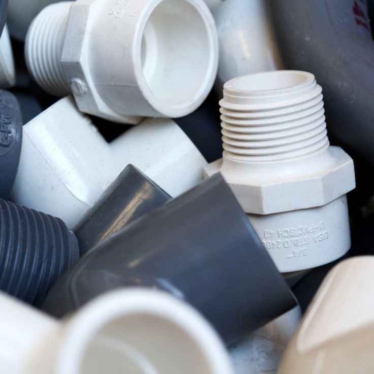 many different types of plastic pipes and fittings are stacked together on top of each other