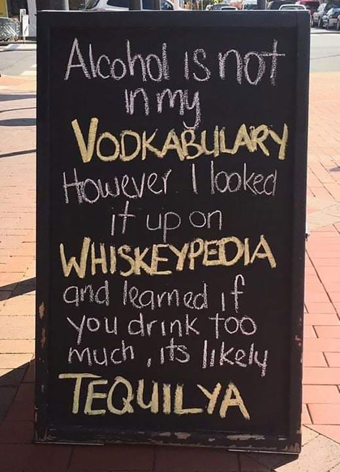 a sign on the sidewalk that says alcohol is not my vodka, however i looked it up on whiskey