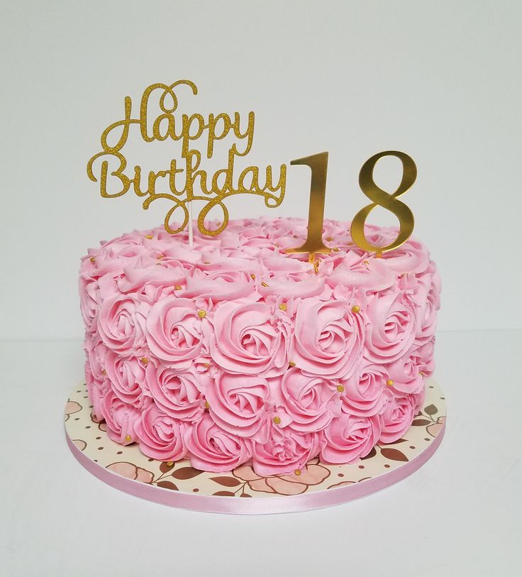 a birthday cake with pink frosting and gold numbers