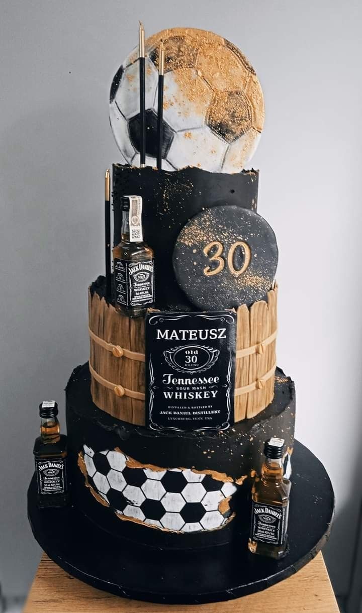 a birthday cake made to look like a whiskey barrel with bottles on it and the number 30