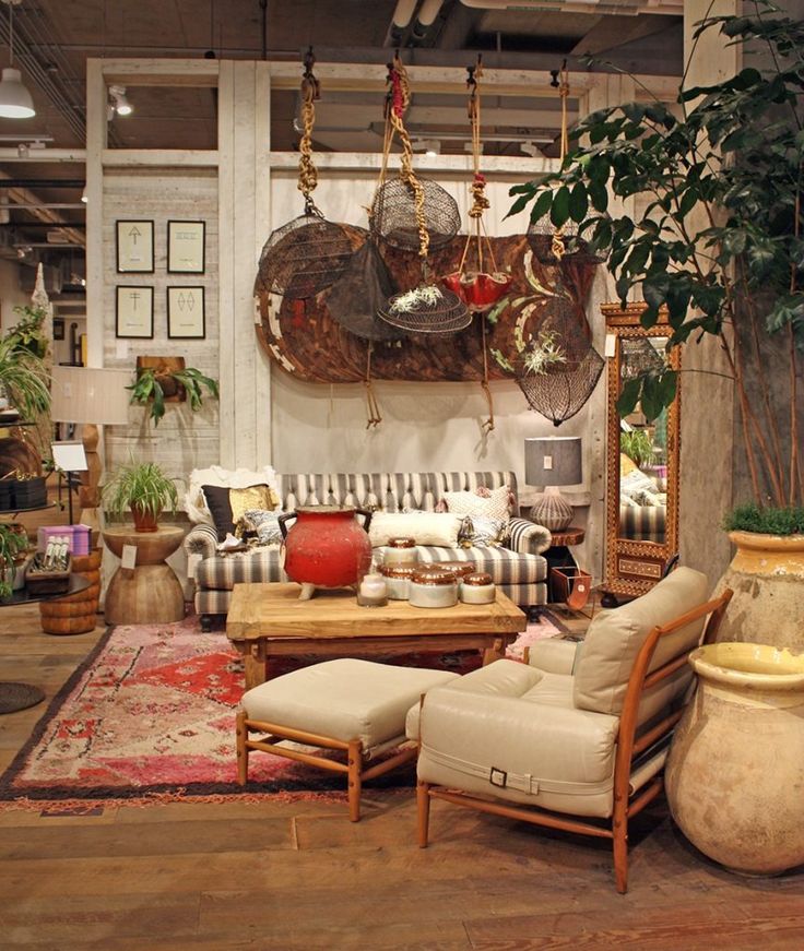 a living room filled with furniture and lots of plants