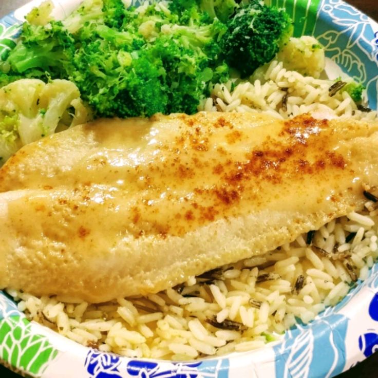 a close up of a plate of food with rice and broccoli on it