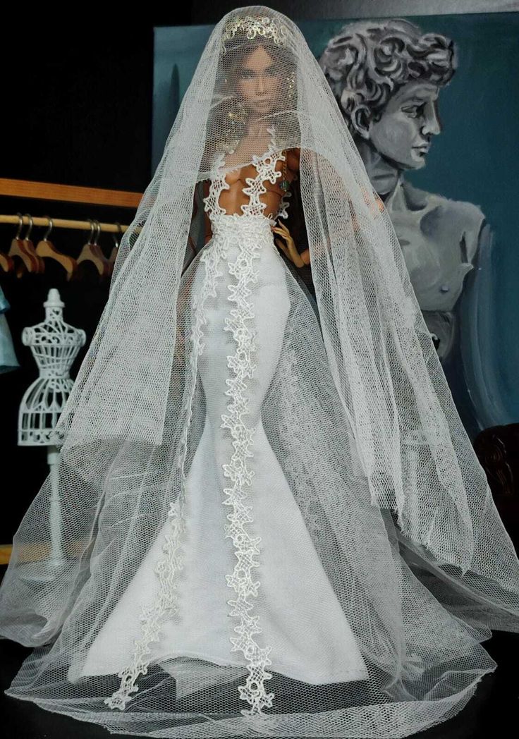 a barbie doll wearing a wedding dress and veil