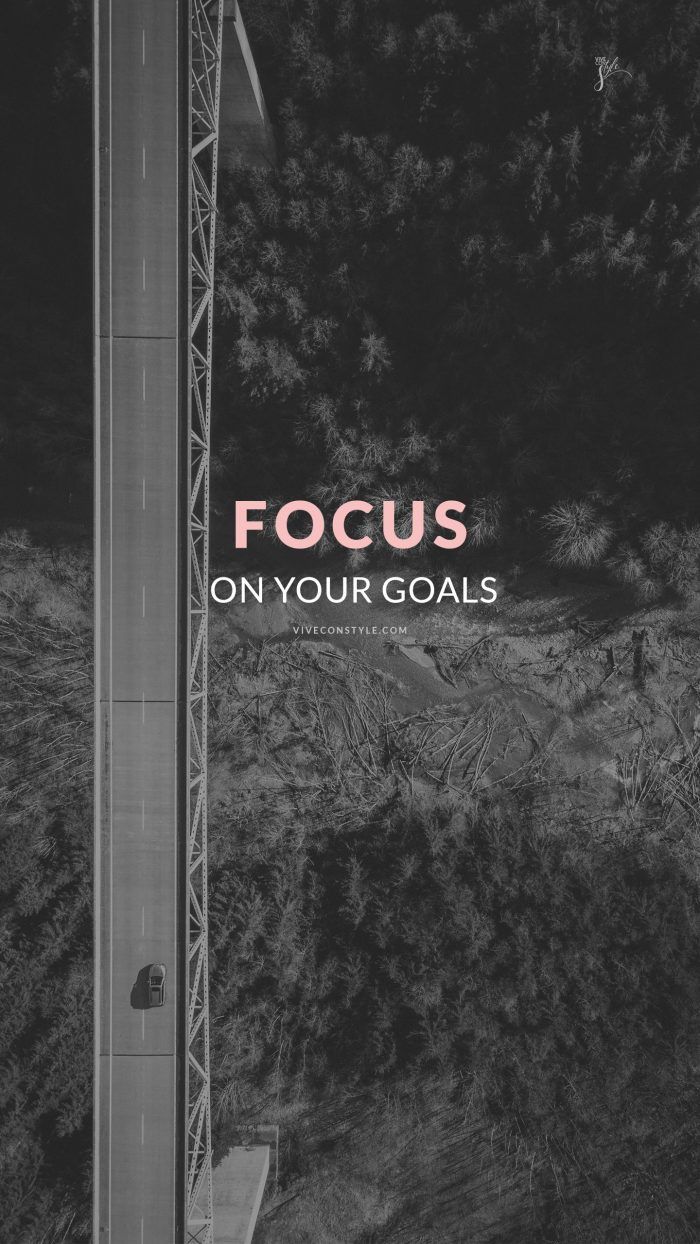 a black and white photo with the words focus on your goals above it is a bridge