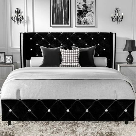 a black and white photo of a bedroom with chandelier above the headboard