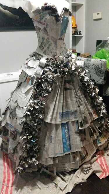 a dress made out of newspapers sitting on top of a table