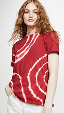 a woman wearing a red shirt with white swirls on it