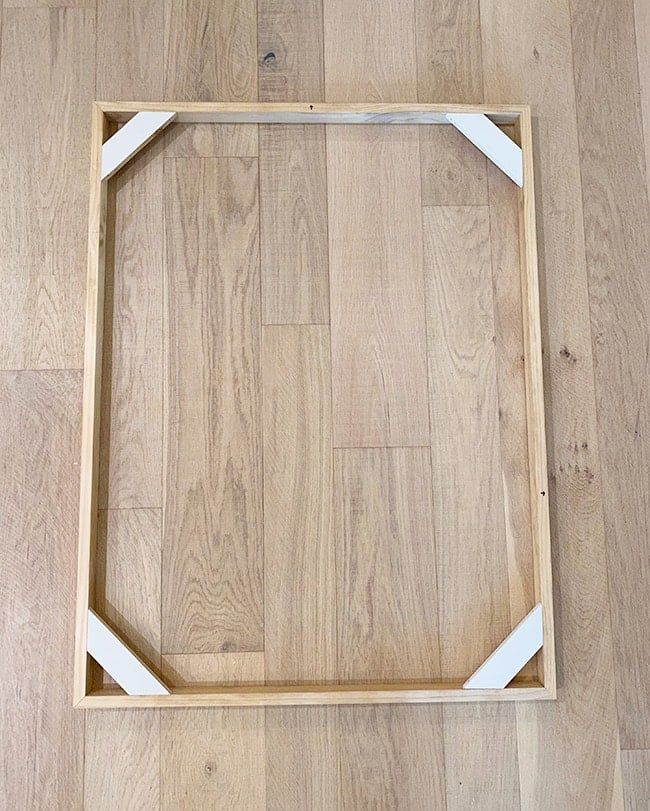 a wooden frame sitting on top of a hard wood floor