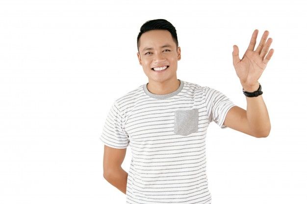 a man is holding his hand up in the air and smiling at the camera while wearing a striped t - shirt