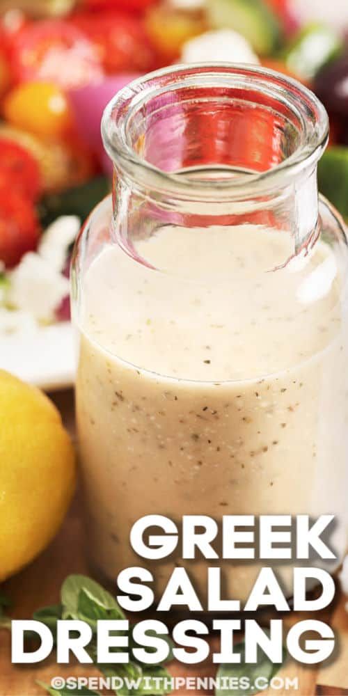 greek salad dressing in a glass jar on a cutting board