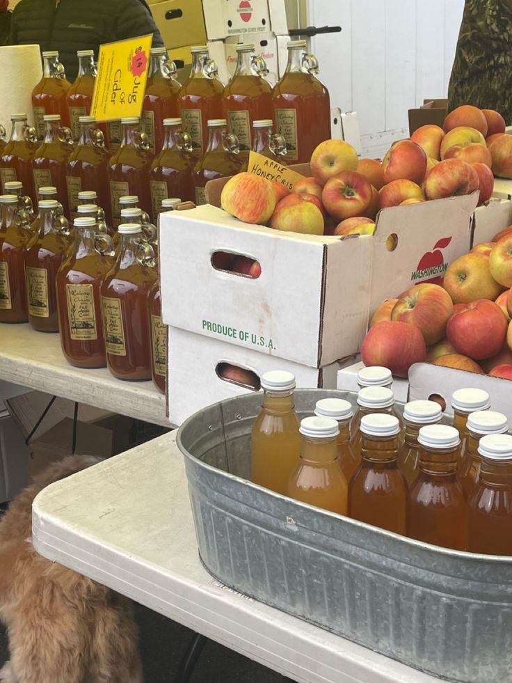 apples and honey are on display at an outdoor market