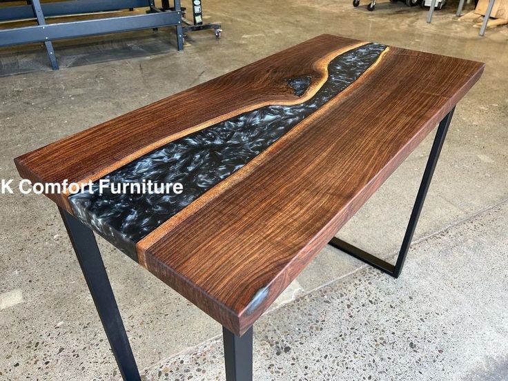 a table made out of wood and metal legs in a room with other items on the floor