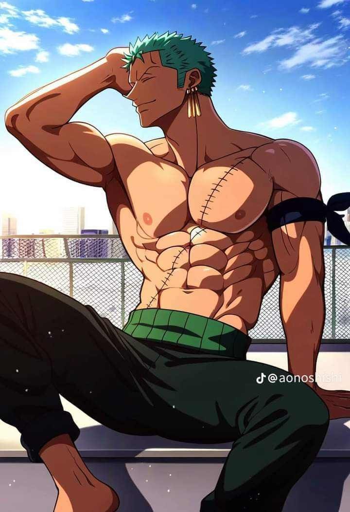 a man with green hair and no shirt sitting on the ground next to a fence